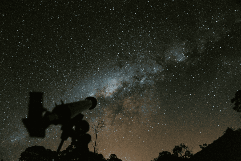 Star gazing in night sky with a telescope